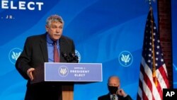President Joe Biden, right, listens as his nominee for the director of the Office of Science and Technology Policy and adviser on science Eric Lander speaks during an event at The Queen theater, Jan. 16, 2021, in Wilmington, Del.