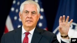FILE - Secretary of State Rex Tillerson gestures while speaking to State Department employees.