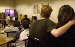 Students and others watch live television coverage of the 9/11 attacks on the UCLA campus in Los Angeles, Sept. 11, 2001.