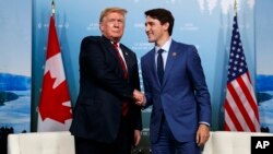 President Donald Trump, left, meets with Canadian Prime Minister Justin Trudeau during the G-7 summit, June 8, 2018, in Charlevoix, Canada.