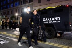 A police officer detains a demonstrator in Oakland, Calif., on June 1, 2020, during a rally for George Floyd, who died in the custody of Minneapolis police on May 25.