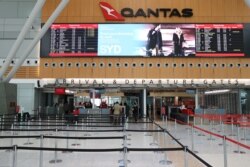 FILE - A mostly empty domestic terminal at Sydney Airport is seen after surrounding states shut their borders to New South Wales, in Sydney, Australia, Dec. 21, 2020.
