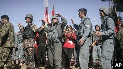 Afghan security forces dance during the second phase of transfer of authority ceremony from the NATO- led troops to Afghan security forces in Qalay-e-Naw, Badghis province, west of Kabul, Afghanistan, January 31, 2012.