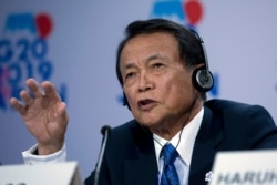 FILE - Japan's Finance Minister Taro Aso speaks during a news conference in the sidelines of the World Bank/IMF Annual Meetings in Washington, Oct. 18, 2019.