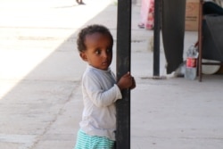 Children growing up in displaced families stay in dangerous, unsanitary camps, often without enough food, clean water or medical care, in Tripoli, Libya, July 3, 2019. (H. Murdock/VOA)