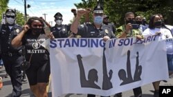 In this Saturday, May 30, 2020, photo, Camden County Police Chief Joe Wysocki marches to protest the May 25 death of George Floyd during an arrest in another state. (April Saul via AP)