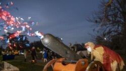 A confetti canon is launched at the Krewe de Jeanne d'Arc drive-thru parade in Behrman Memorial Park in Algiers for the start of Twelfth Night in New Orleans on Wednesday, Jan. 6, 2021. (Chris Granger/The Times-Picayune/The New Orleans Advocate via AP)
