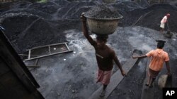 Para pekerja tambang India memindahkan batubara ke dalam sebuah truk di kota Gauhati, India (foto: dok). Pemerintah India diduga memberikan kontrak batubara kepada perusahaan swasta tanpa tender yang transparan. 