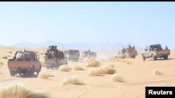 FILE - Yemeni government army soldiers ride on the back of pick-up trucks at the frontline of fighting against Houthis in Marib, Yemen, in this undated photo provided by Yemen's Armed Forces. Jan. 14, 2022. (Yemeni Armed Forces/Handout via Reuters)