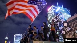 Protestors stand next to a U.S. flag as they attend a gathering at the Edinburgh place in Hong Kong, China, November 28, 2019.