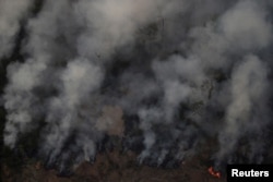 Smoke billows during a fire in an area of the Amazon rainforest near Porto Velho, Rondonia State, Brazil, Brazil August 21, 2019.