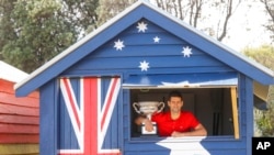 FILE - Serbia's Novak Djokovic poses with Norman Brookes Challenge Cup the day after after defeating Russia's Daniil Medvedev in the men's singles final at the Australian Open tennis championship in Melbourne, Australia, Feb. 22, 2021. 