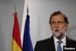 FILE - Spain's Prime Minister Mariano Rajoy delivers a statement at the Moncloa Palace in Madrid, Spain, Oct. 27, 2017.