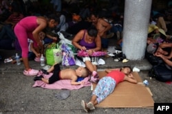 Honduran migrants taking part in a caravan heading to the US, rest in Tapachula, Chiapas state, Mexico, Oct. 21, 2018.