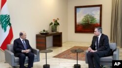 In this photo released by Lebanon's official government photographer Dalati Nohra, Lebanese President Michel Aoun, left, meets with Lebanese Prime Minister-designate Mustapha Adib, at the Presidential Palace near Beirut, Lebanon, Sept. 26, 2020.