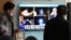People watch a TV screen showing a local news program reporting about North Korea's missile launch, at the Seoul Railway Station in Seoul, South Korea, Nov. 30, 2017. 