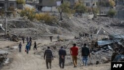 FILE - People arrive in Sirnak city on Nov. 14, 2016, after a 246-day curfew was partially lifted. The curfew in Sirnak, a city of 290,000, was imposed on March 14 as part of operations to eradicate the PKK from eastern Turkey.