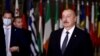 FILE — Azerbaijani President Ilham Aliyev, right, stands in Brussels on Dec. 15, 2021. Azerbaijan is set to hold snap presidential elections on Wednesday, with seven candidates vying for the top position; Aliyev is expected to secure victory.