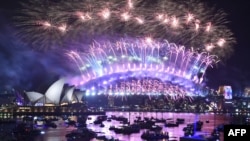 FILE - New Year's Eve fireworks erupt over Sydney's iconic Harbour Bridge and Opera House in Australia, during the fireworks show, Jan. 1, 2019.