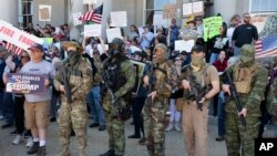 People, including those with the boogaloo movement, demonstrate against business closures due to concern about COVID-19, at the State House in Concord, N.H., May 2, 2020.