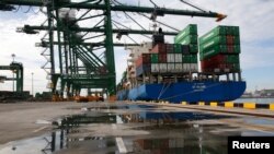 FILE - A ship is unloaded at New Priok Container Terminal One in Tanjung Priok, north Jakarta, Indonesia, Nov. 16, 2016.