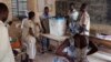 Poll workers count ballots after the end of voting in Mali's presidential elections in Timbuktu Jul. 28, 2013.