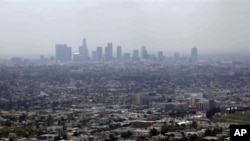 FILE - Smog from smokestacks, diesel engines, automobiles, and other sources of pollution, Los Angeles, April 2009.
