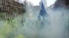 Demonstrators, called the yellow jackets, holds up an EU flag during a protest against rising fuel prices in Brussels, Friday, Nov. 30, 2018.