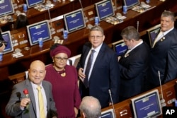 From left, Carlos Lozada, Victoria Sandino, Pablo Catatumbo, Marco Calarca and Olmedo Ruiz, all former members of the demobilized Revolutionary Armed Forces of Colombia, arrive at Congress to take up seats in the newly elected legislature, in Bogota, Colombia, July 20, 2018.