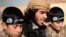 А YouTube screen grab from an Islamic State propaganda video shows an IS recruiter with two child soldiers. Children as young as eight years old are reportedly being trained to serve in roles ranging from spies, to front line soldiers, to suicide bombers.
