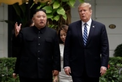 FILE - U.S. President Donald Trump and North Korean leader Kim Jong Un take a walk after their first meeting at the Sofitel Legend Metropole Hanoi hotel in Hanoi, Vietnam, Feb. 28, 2019.