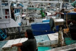 FILE - Fishermen rest after tying their boats at the northeast fishing port in Yilan, Taiwan, July 7, 2016.
