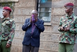 A man reacts outside the Lee Funeral Home following the death of Kenya's retired president Daniel Arap Moi in Nairobi, Feb. 4, 2020.