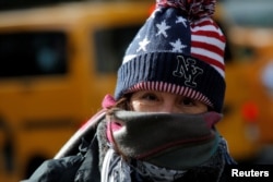 Bundling up against the cold in New York's Times Square and the entire Northeast is advised this New Year's weekend.