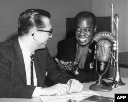 FILE - VOA jazz broadcaster Willis Conover interviews the legendary Louis Armstrong.