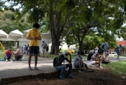 People gather in Martyrs Park where wifi connections are working in Havana, Cuba, July 13, 2021. Cuban President Miguel Díaz-Canel is accusing Cuban Americans of using social media to spur Sunday's nationwide antigovernment protests.
