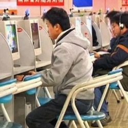FILE - Users surf the web at an internet cafe in China.