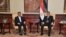 Egyptian President Mohamed Morsi (R), meets with Iran's President Mahmoud Ahmadinejad after he arrives at International Airport in Cairo in this photo provided by the Egyptian Presidency, February 5, 2013.