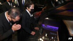 Lee Soon-ja, second from right, the wife of the late former South Korean President Chun Doo-hwan, watches the casket containing the body of her husband at a funeral hall in Seoul, South Korea, Nov. 27, 2021.