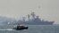 A Turkish Navy cost guard boat (L) escorts the Russian Navy destroyer Smetlivy, in the Bosphorus in Istanbul, July 11, 2012. 