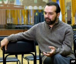 FILE - Viktor Shenderovich speaks during pre-election meeting at a Moscow school in this Nov. 28, 2005 picture.