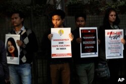 FILE - Indians hold placards during a protest against an alleged rape in New Delhi, India.