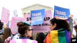 Protesters gather outside the Supreme Court in Washington, Oct. 8, 2019, where justices have begun to hear arguments in the first case of LGBT rights since the retirement of Supreme Court Justice Anthony Kennedy in July of 2018.