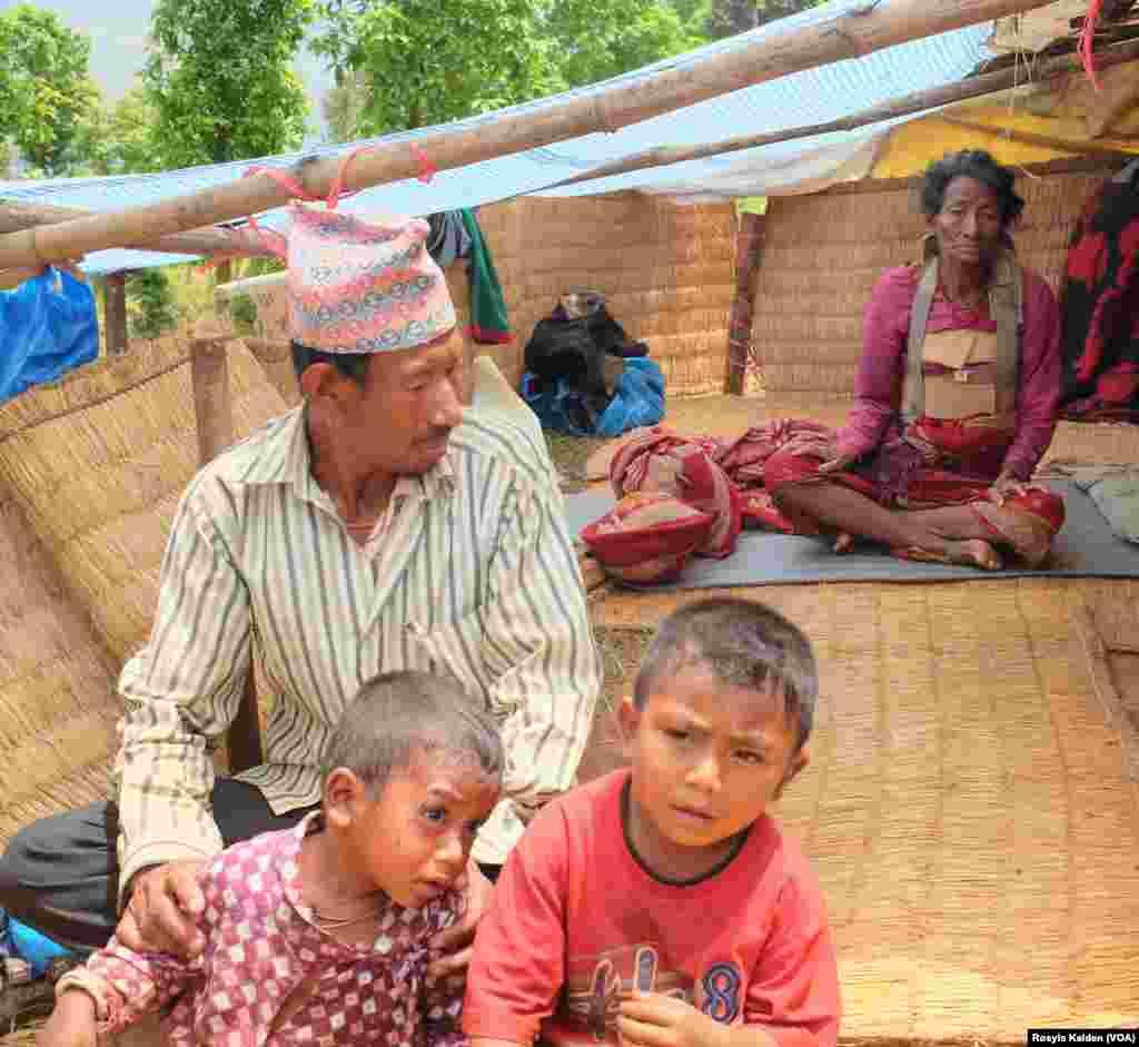 A 3-year-old boy, left, and his grandmother, rear, were removed from the rubble of their home in Ratomatey and await treatment for their injuries.