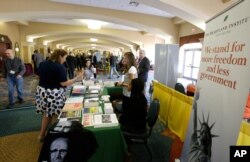 Delegates stop by one of the many information booths at the National Libertarian Party Convention in Orlando, Fla., May 27, 2016.