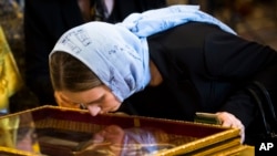 In this photo taken May 26, 2017, an Orthodox believer kisses the relics of Saint Nicholas that were brought from an Italian church where they have lain for 930 years, in the Christ the Savior Cathedral in Moscow, Russia.