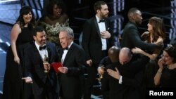 Jimmy Kimmel and Warren Beatty laugh after correcting the Best Picture Oscar from La La Land to Moonlight. 