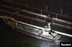 A 2,591-tonne tanker, which is sent by strong wind caused by Typhoon Jebi, crashes into a bridge connecting Kansai airport, which is built on a man-made island in a bay, to the mainland, in Izumisano, western Japan, in this photo taken by Kyodo, Sept. 4,