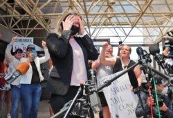 Salon owner Shelley Luther reacts as supporters chant for her after she was released from jail in Dallas, May 7, 202 for refusing to keep her business closed amid concerns of the spread of COVID-19.