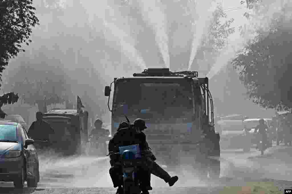 A vehicle of the Water and Sanitation Agency (WASA) sprays water using an anti-smog gun to curb air pollution amid heavy smoggy conditions in Lahore, Pakistan.